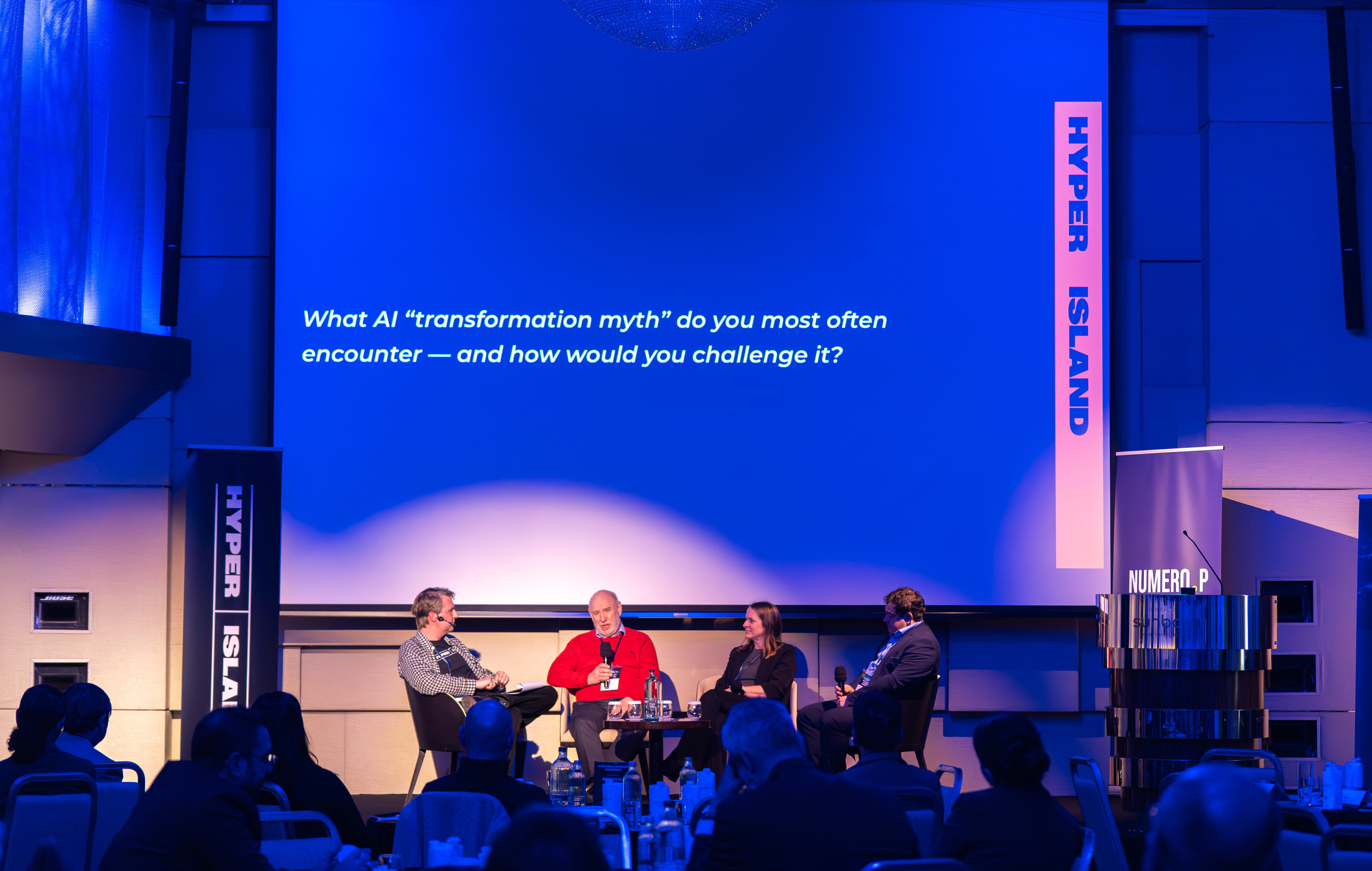 Panel discussion at the Gibraltar AI Futures and Foresight Conference with a slide asking, “What AI transformation myth do you most often encounter?”