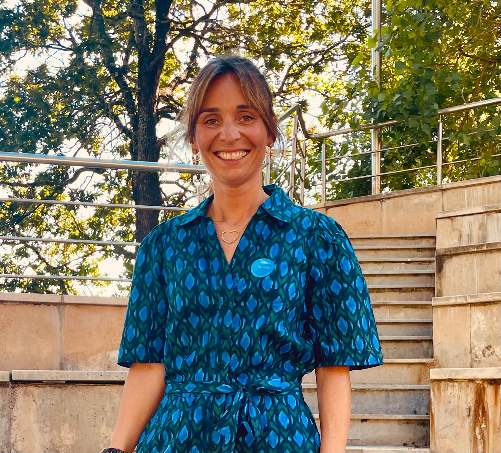Hyper Island facilitation course participant Benedita Salinas smiling outdoors in front of stone steps and trees.